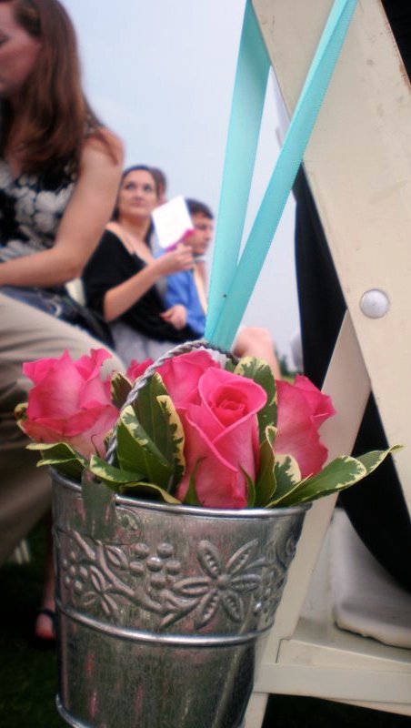 Little silver buckets of hotpink roses tied with tiffany blue 